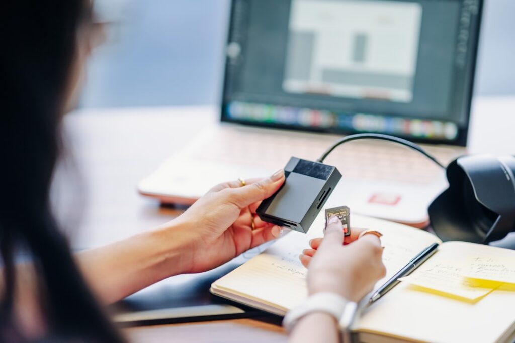 Person connecting external hard drive to card reader